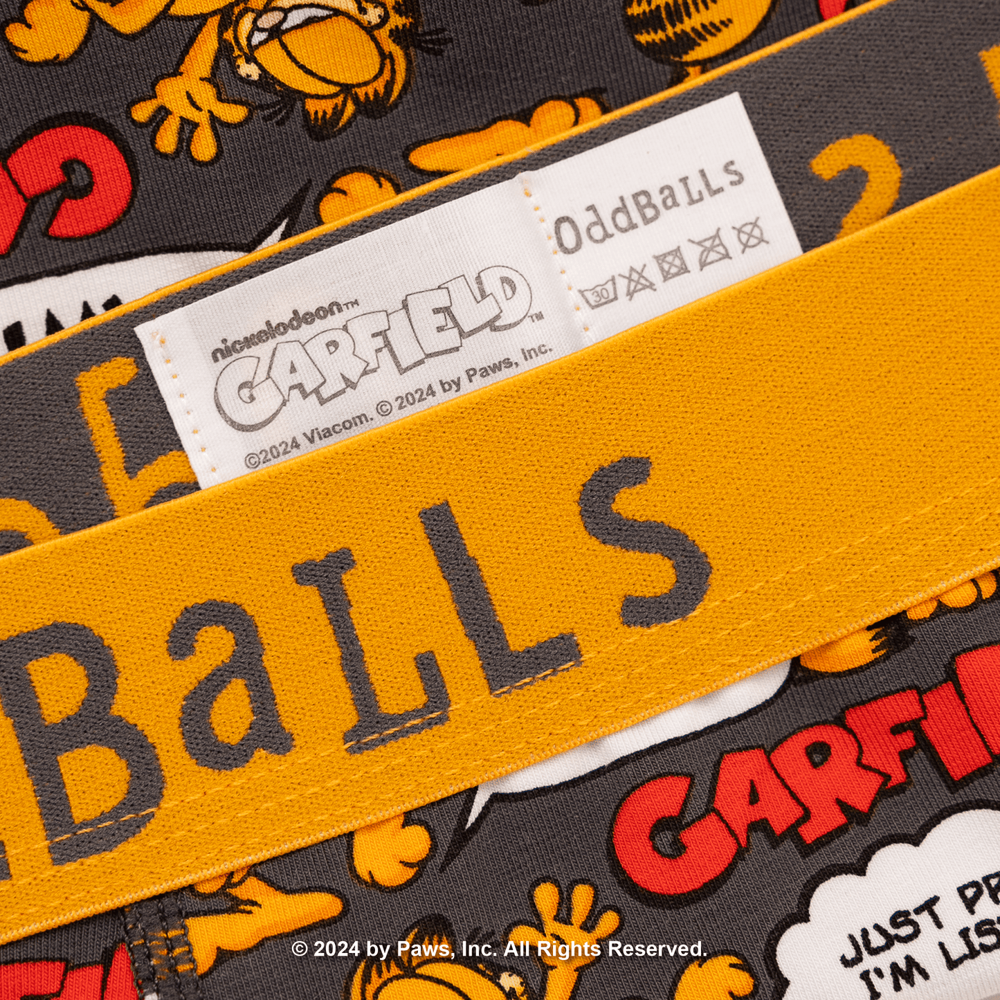 Close-up of a product with 'Garfield' branding and text, featuring the brand name 'OddBalls'.